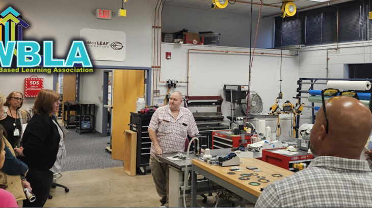 The board of directors and visitors tour the lab at AB Tech
