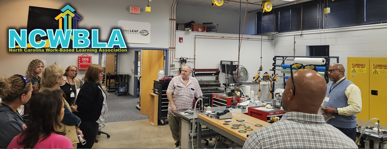 The board of directors and visitors tour the lab at AB Tech